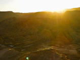 Sunset casting golden light over the rugged terrain of our mining site.