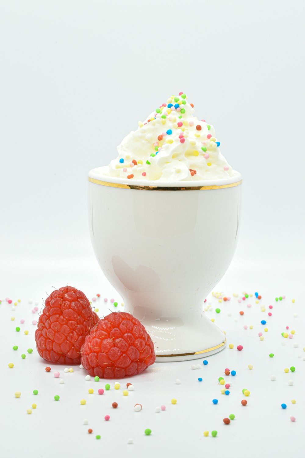 a cupcake with a white frosting and red berries