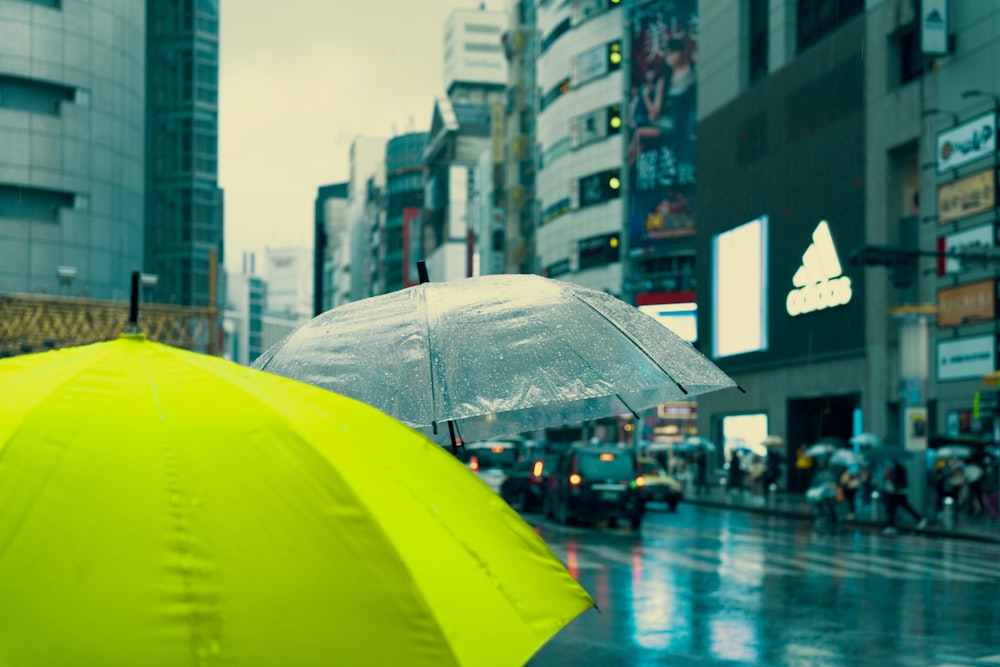 a couple of umbrellas sit on a sidewalk