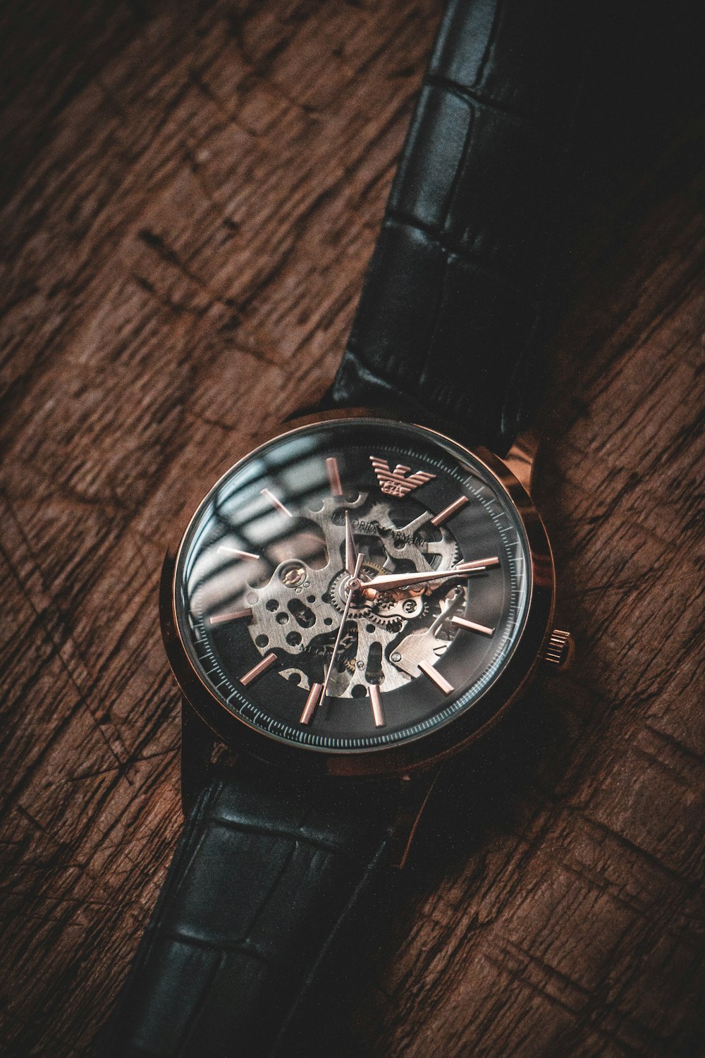 a black watch on a wooden surface