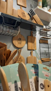 A cozy kitchen counter displaying a variety of shiny chef knives and cutting boards.