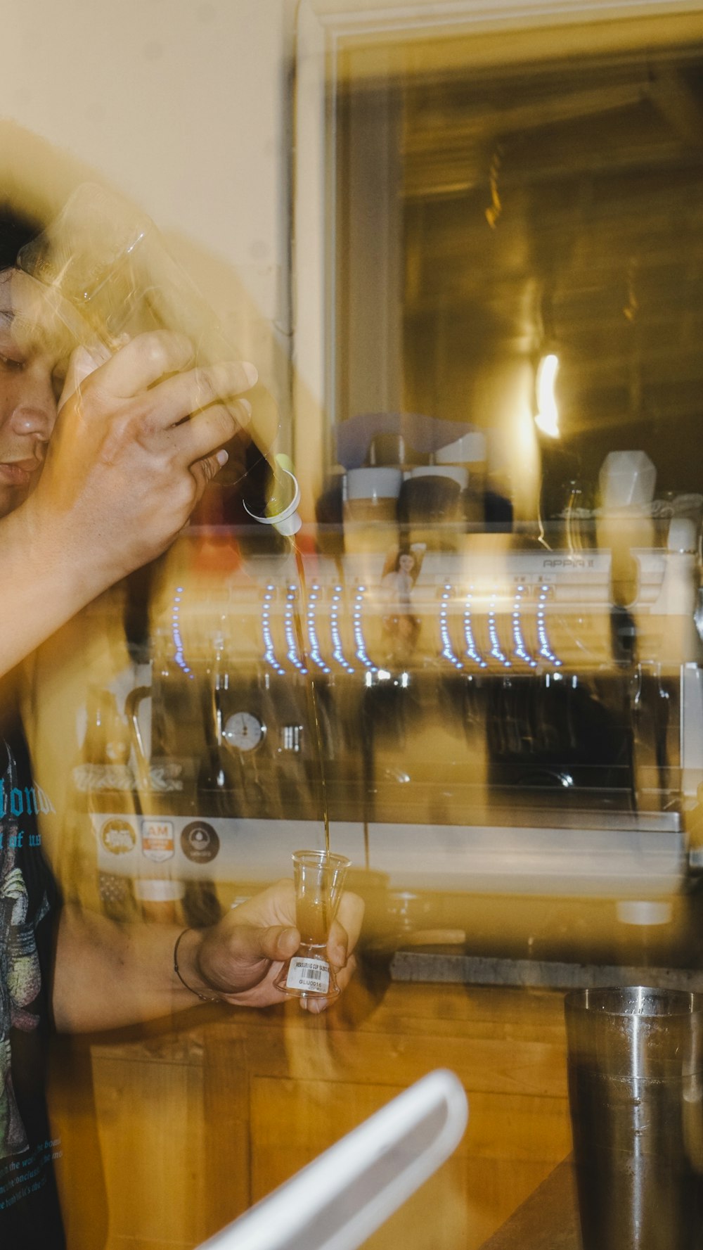 a person holding a glass of beer