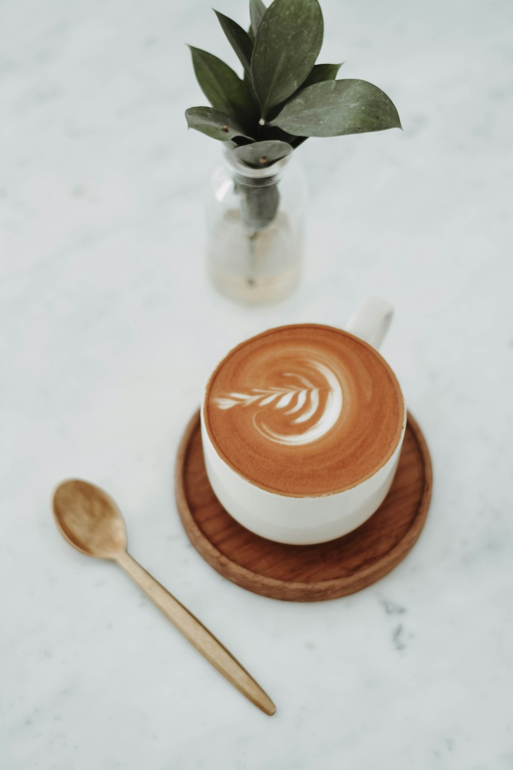 a brown cup with a spoon and a brown liquid in it