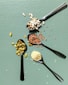 a group of spoons with food on them