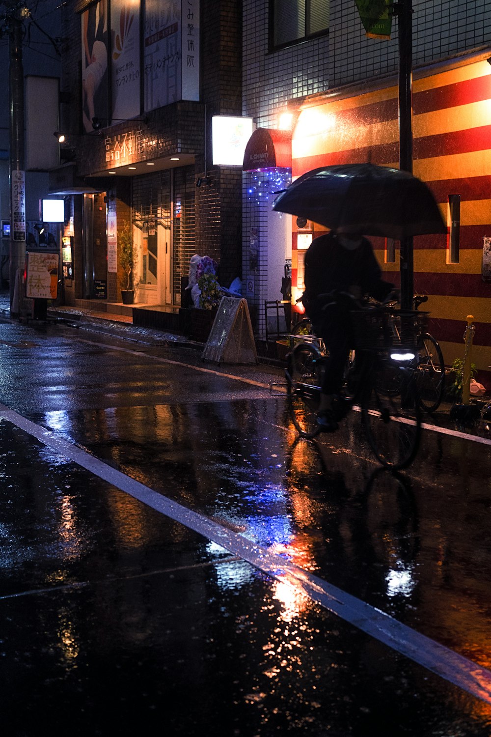 a person riding a bicycle with an umbrella