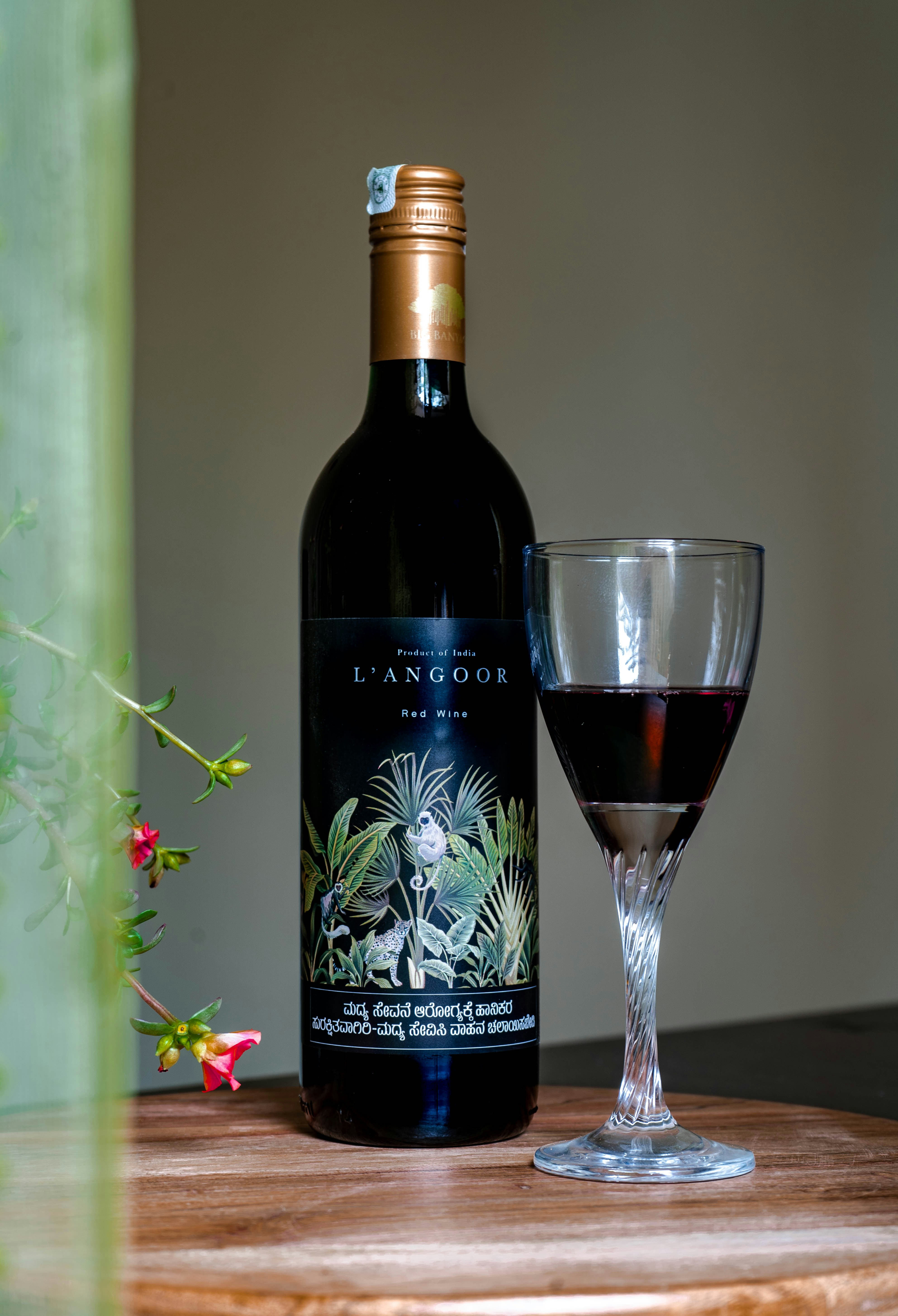 a bottle of wine next to a glass of wine