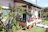 A charming guest house exterior with a small garden and a welcoming front porch.