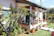 A charming guest house exterior with a small garden and a welcoming front porch.