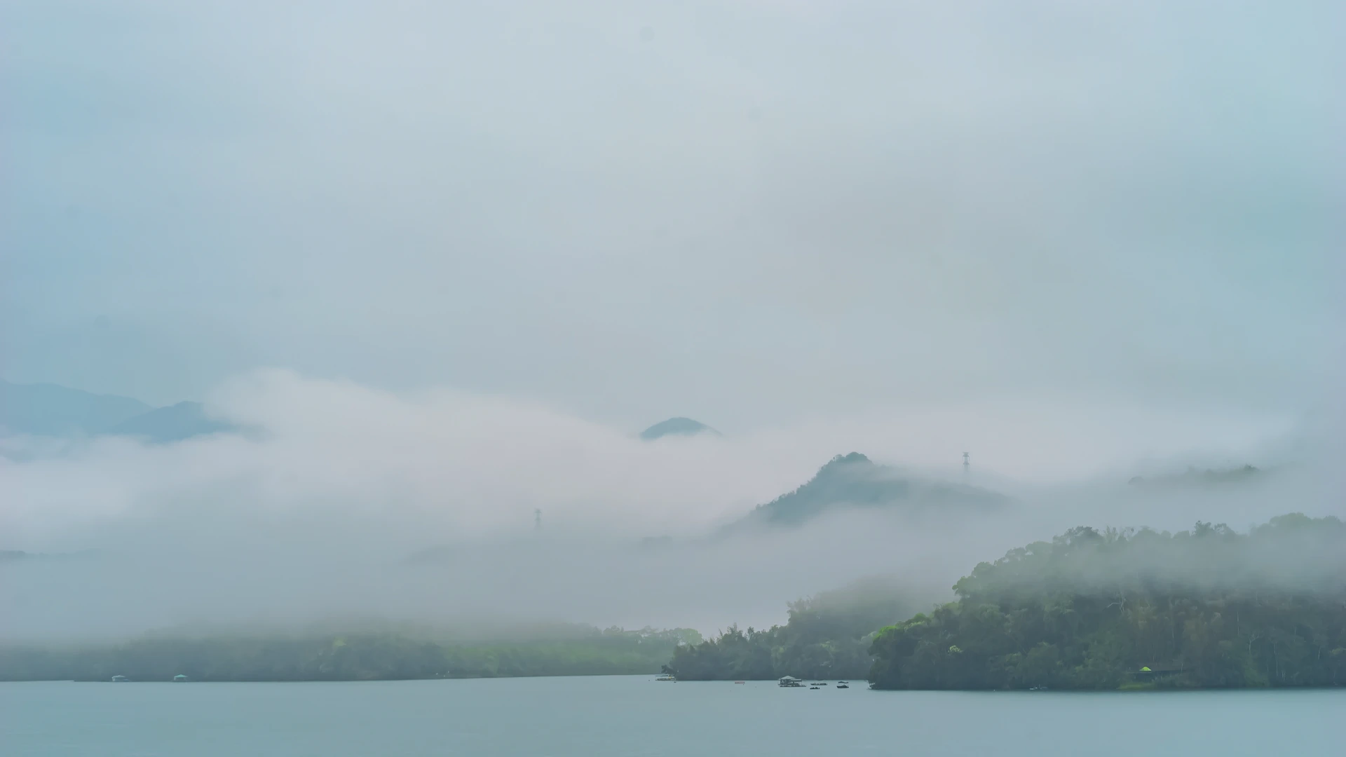 a body of water with trees and mountains in the background