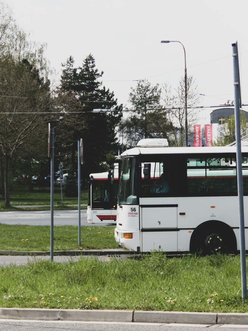 a couple of buses parked on the side of a road