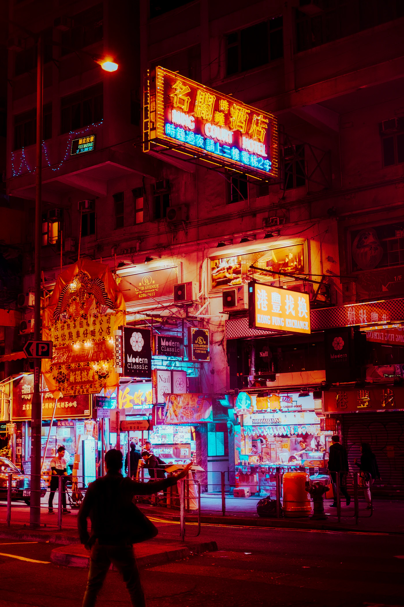 Neon-lit city street at night
