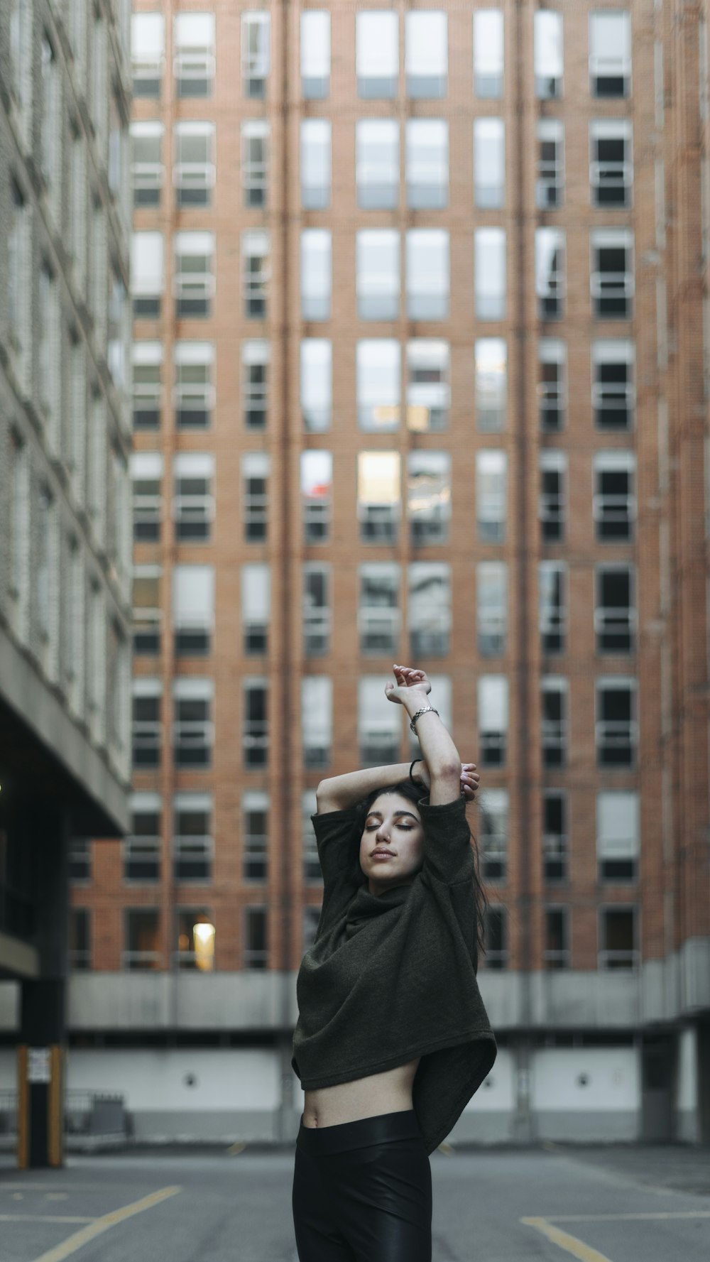 a person posing in front of a building