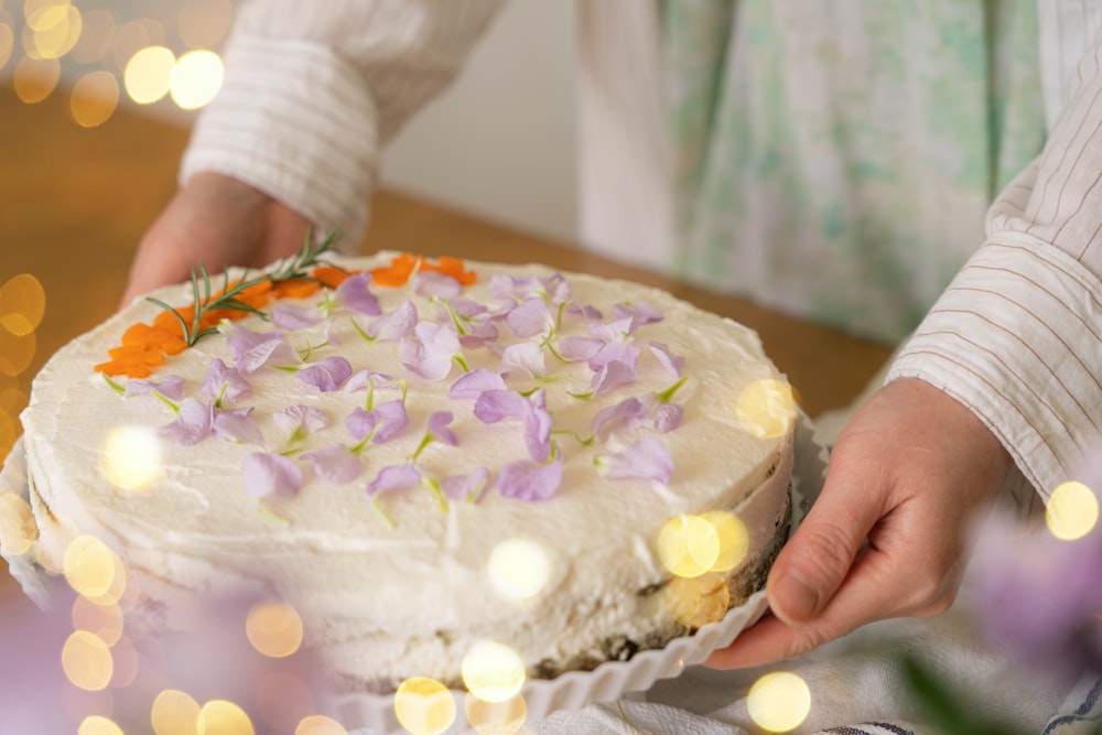 a person holding a cake