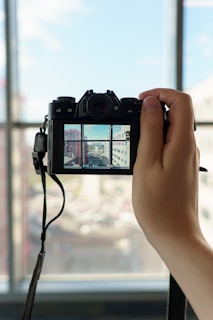 a hand holding a camera