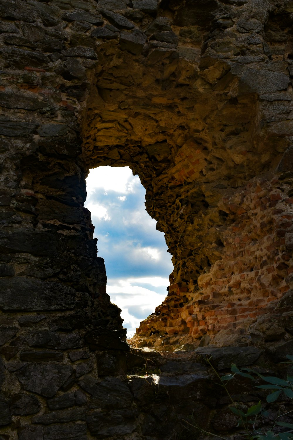 a stone wall with a hole in it