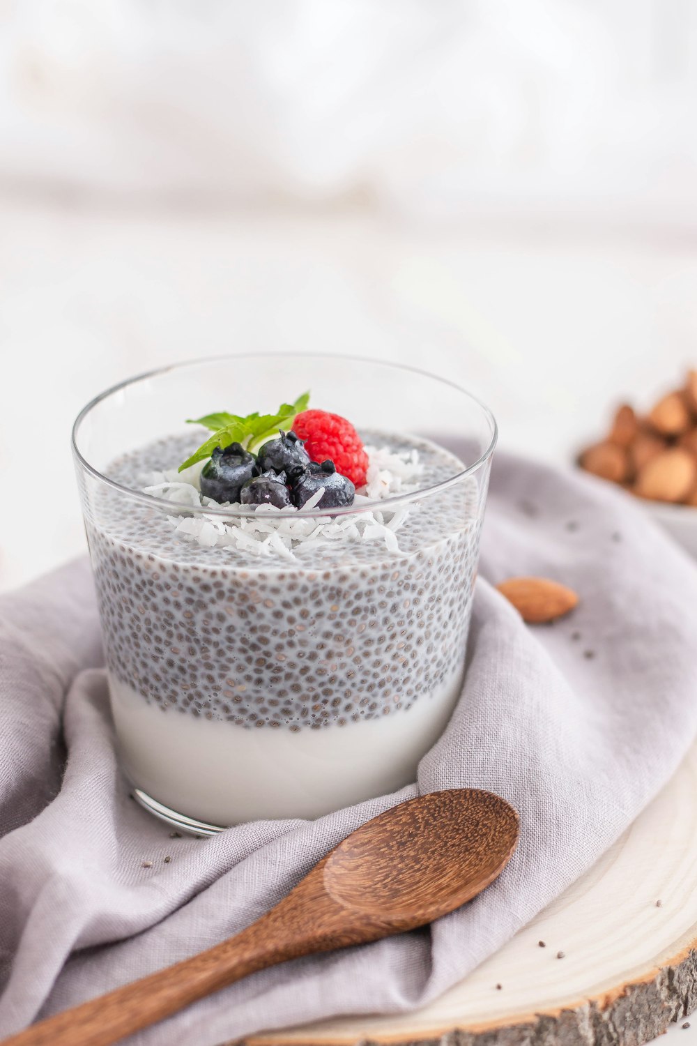 a glass of milk with berries on top