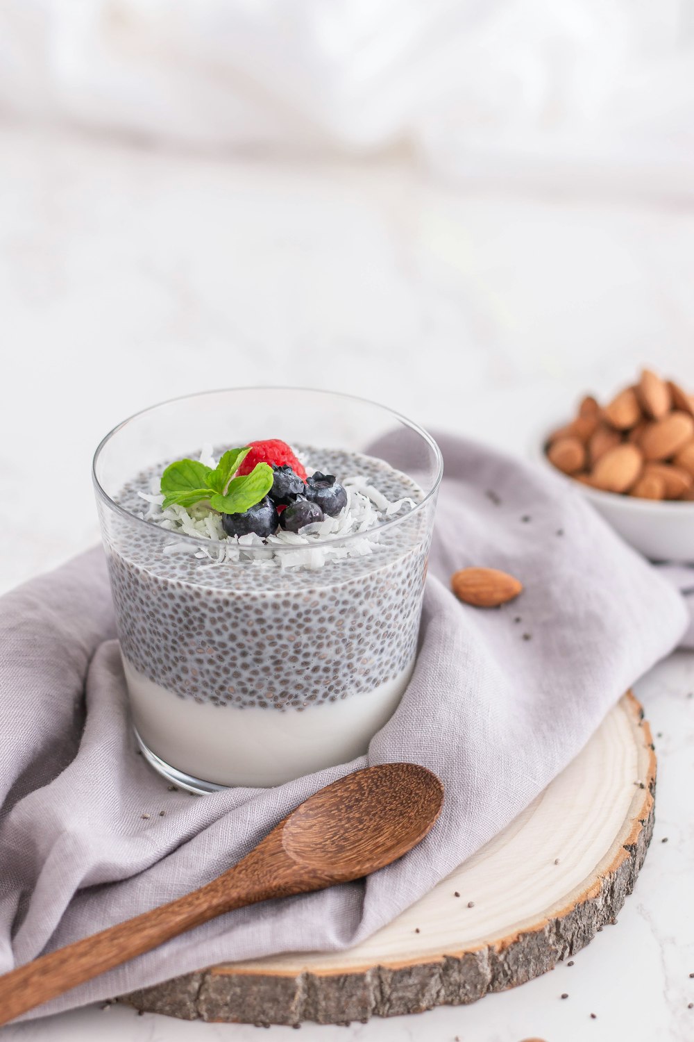 a glass of milk with berries and a spoon