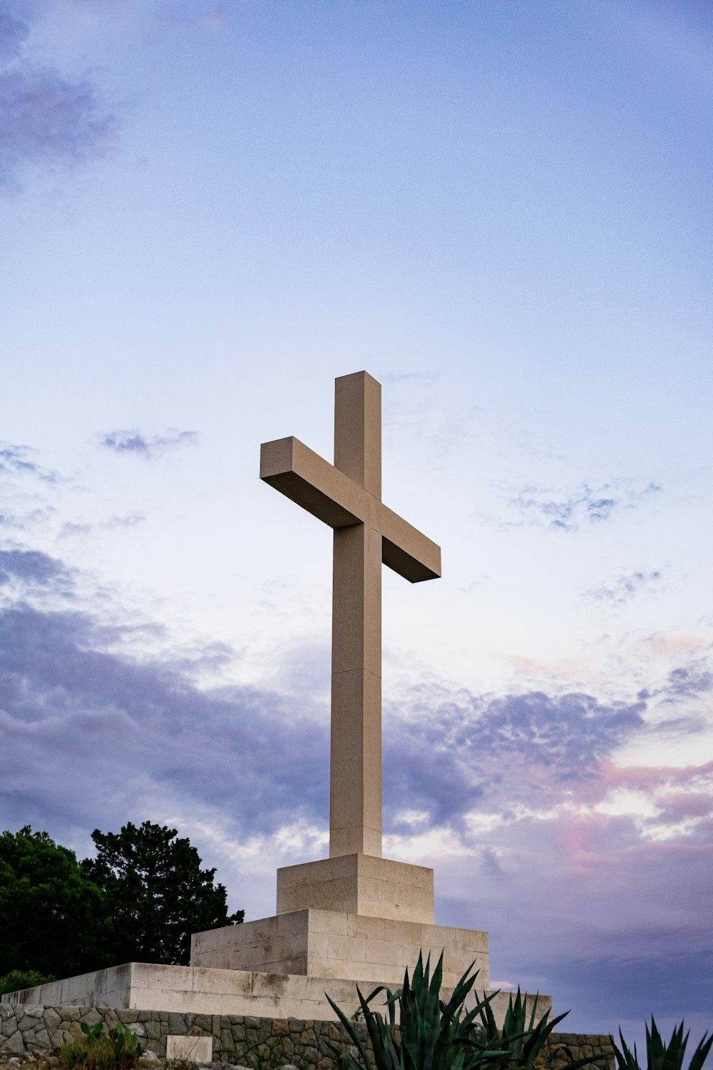 a large cross on a stone wall