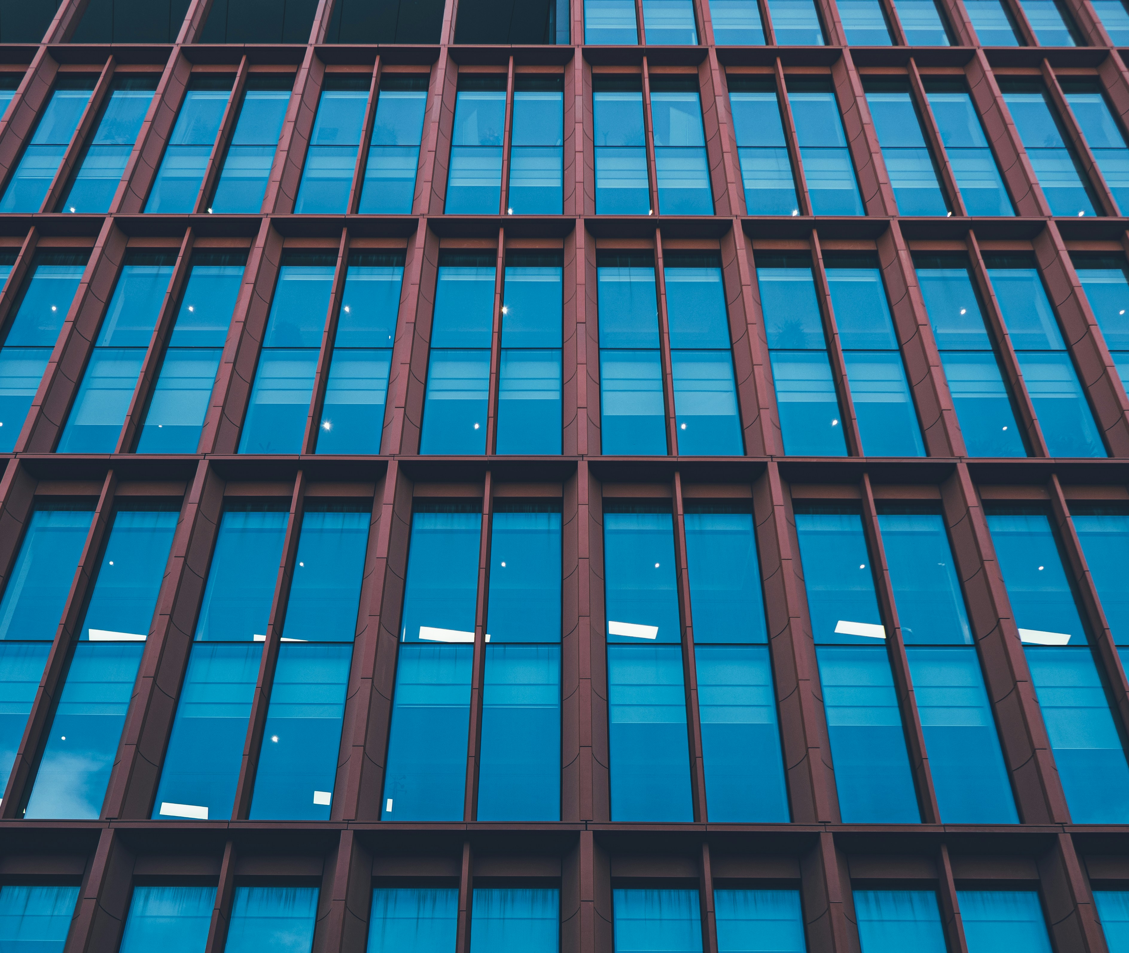 a building with many windows, A colourful and reflective outside of a building in Manchester.
