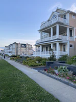 A real estate agent handing over keys to happy new homeowners in an upscale neighborhood.