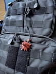 Close-up of a tactical vest with black base and green accents, emphasizing durability and design.