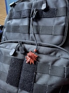Close-up of a tactical vest with black base and green accents, emphasizing durability and design.