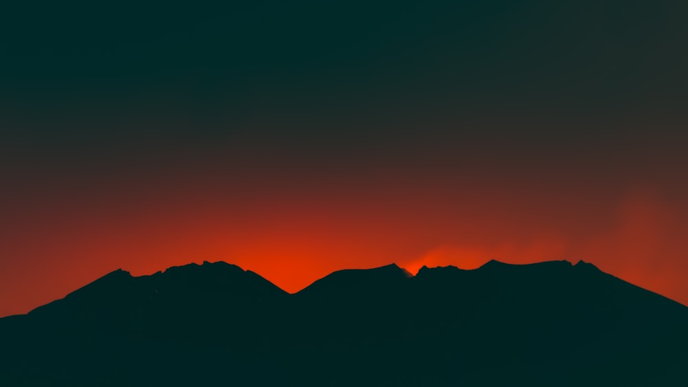 a mountain range at sunset