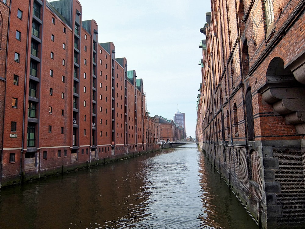 a canal between two brick buildings