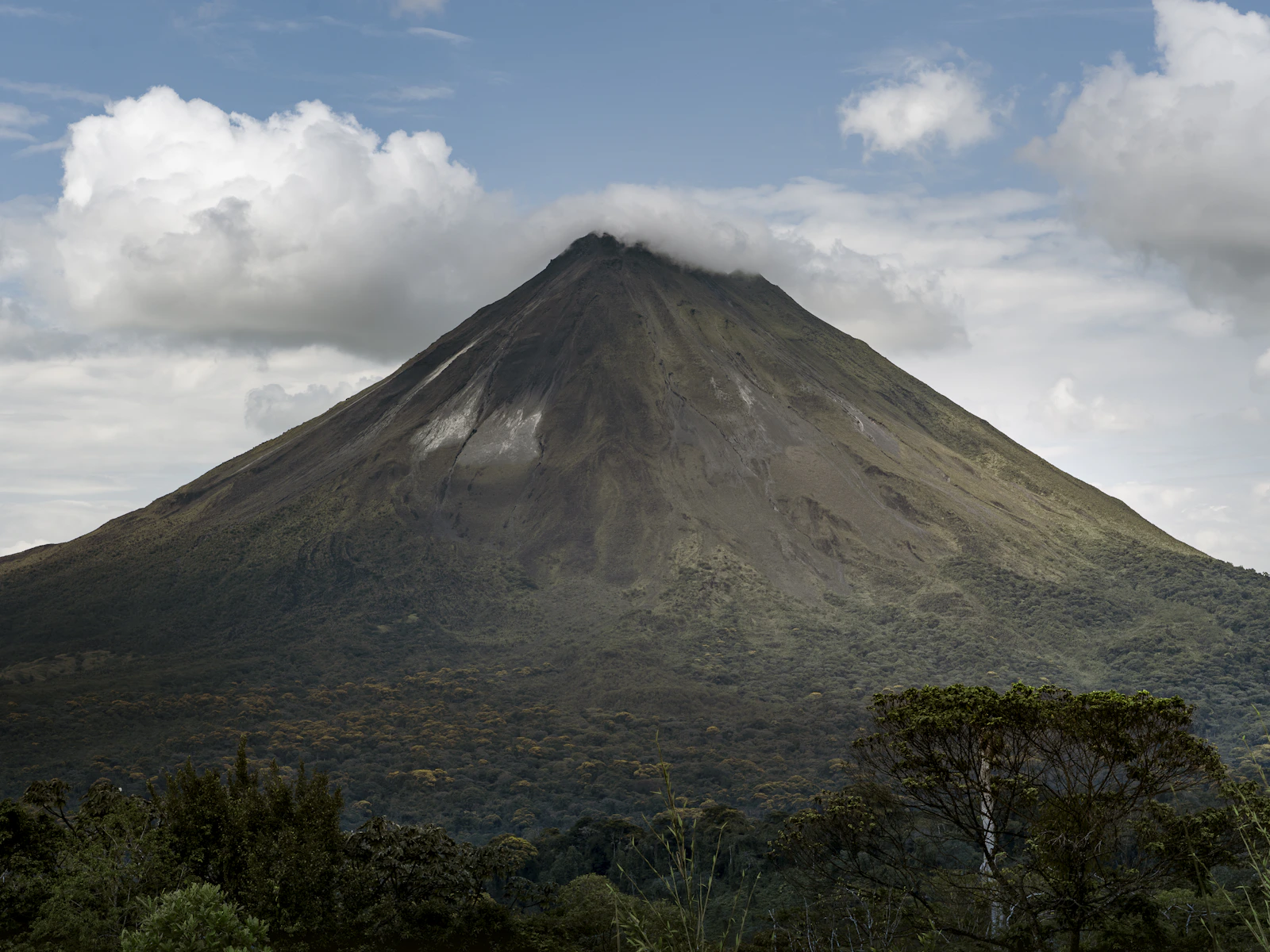 Arenal Volcano rising above lush rainforest in Costa Rica