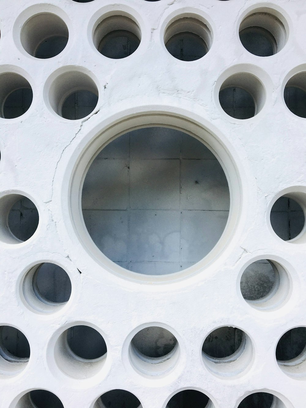 a white circular object with holes