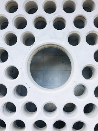 a white circular object with holes
