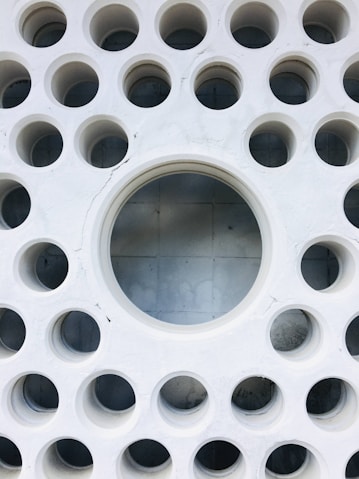 a white circular object with holes