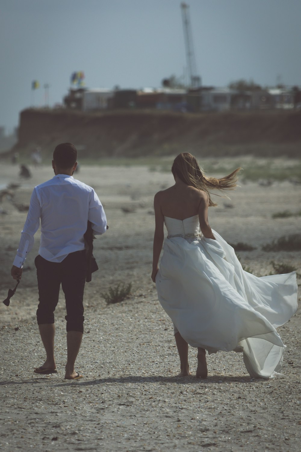 a man and woman walking on a beach