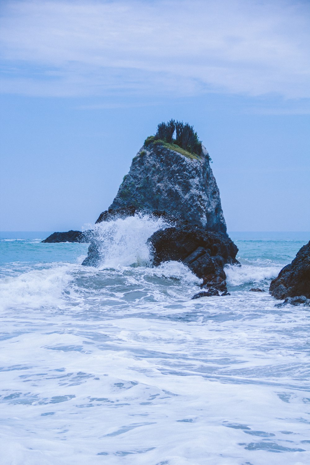 a large rock in the ocean