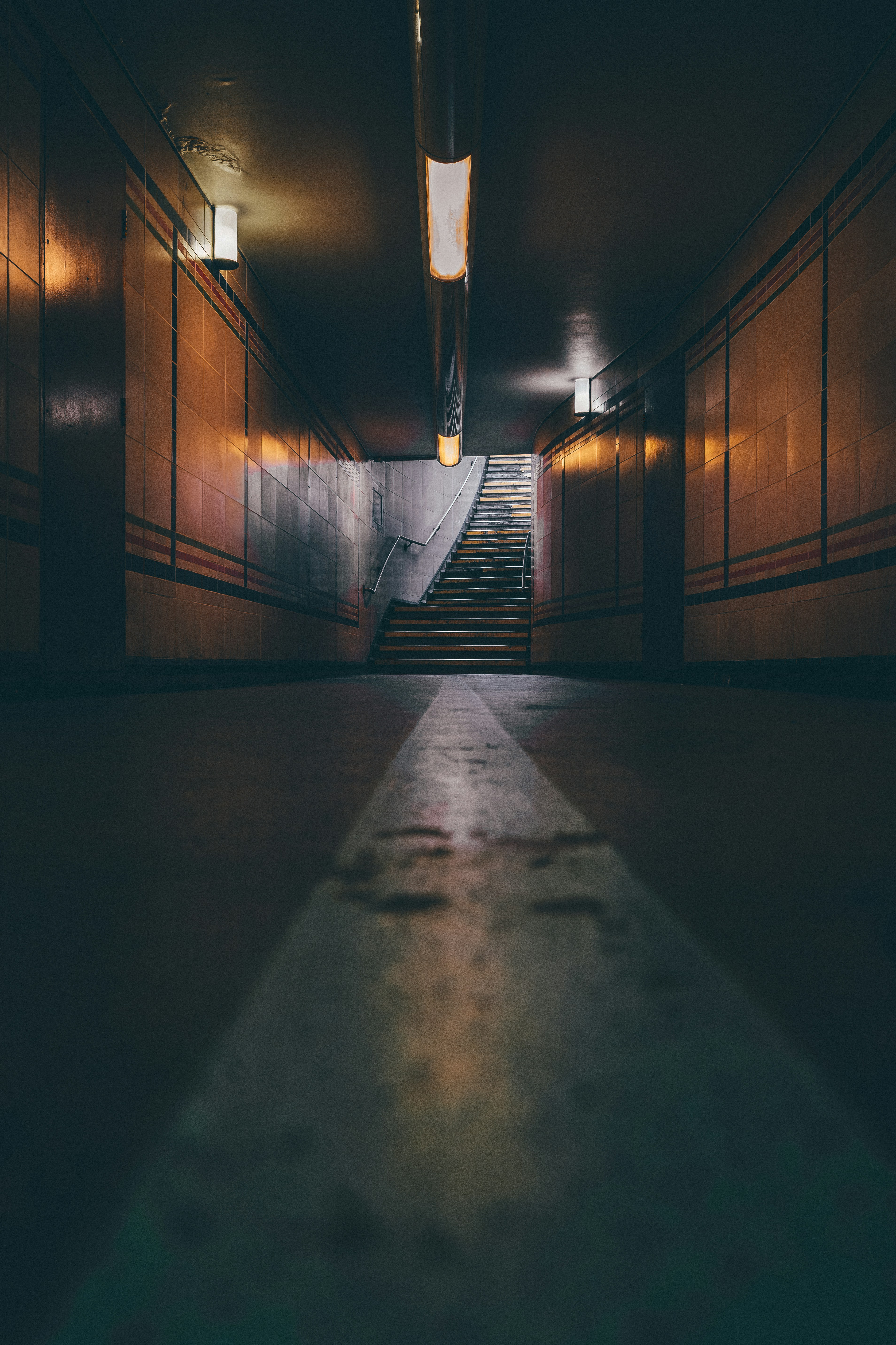a dark stairwell with a light on the top