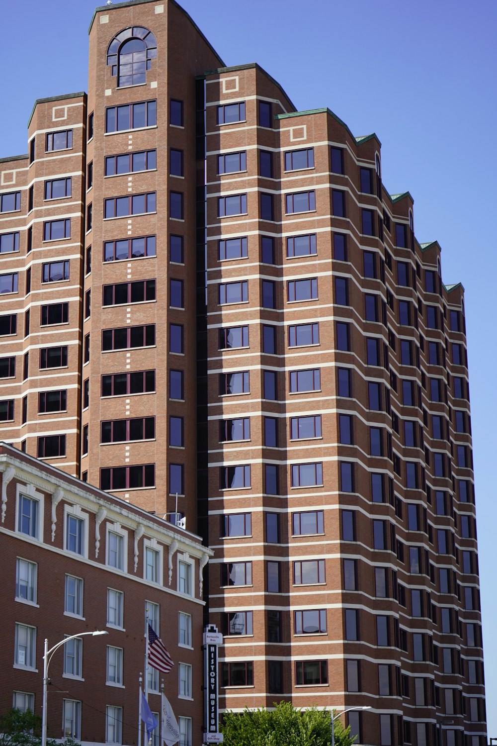 a tall building with flags in front