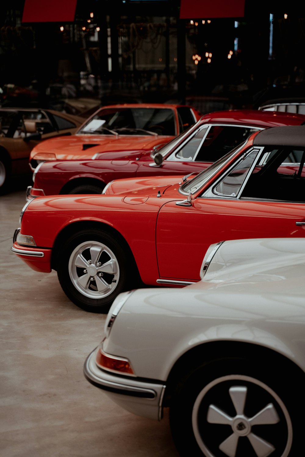 a row of cars parked in a showroom