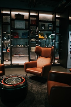 a room with a glass case and chairs