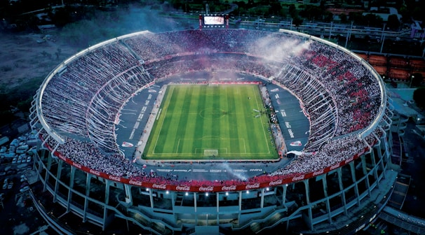 a stadium with a green field