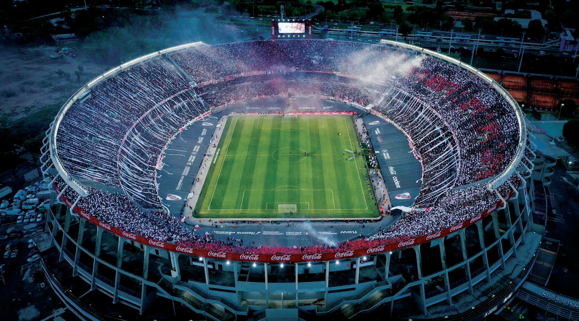 a stadium with a green field
