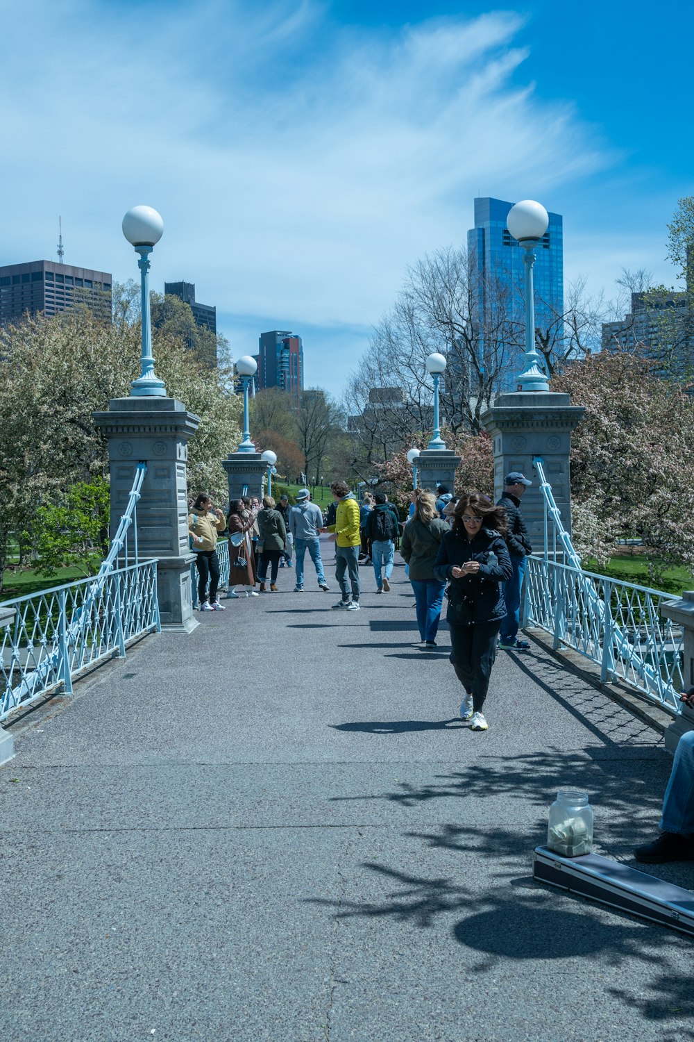 a group of people walking on a path with a tower in the background