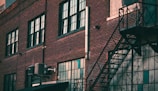 a brick building with windows and a staircase