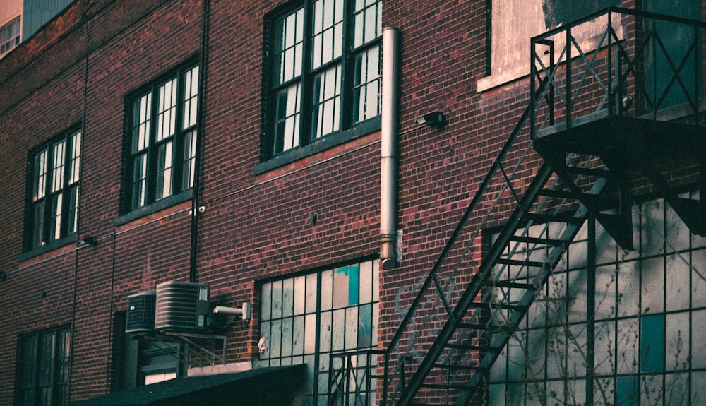 a brick building with windows and a staircase