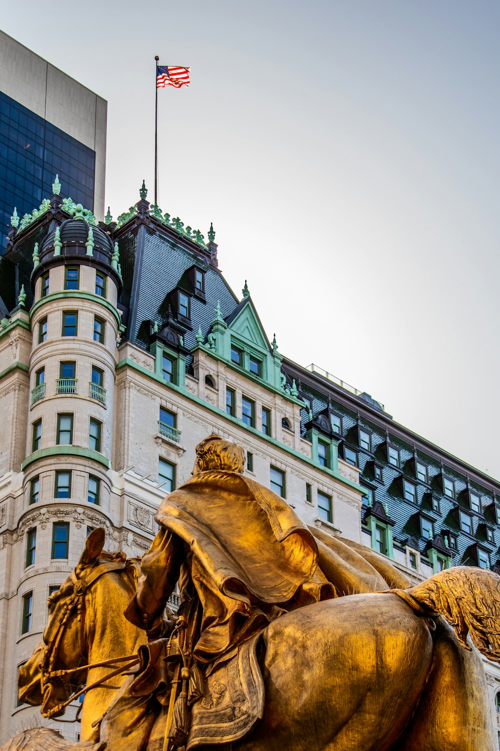 a statue of a person and a flag on top of a building