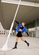 Model showcasing a modern, minimalistic outfit in an outdoor city setting.