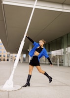 A model showcasing a modern outfit in an urban setting.