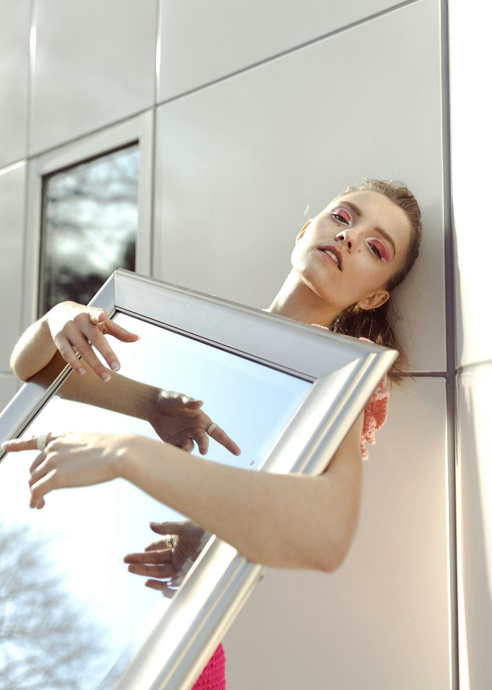 a woman holding a mirror