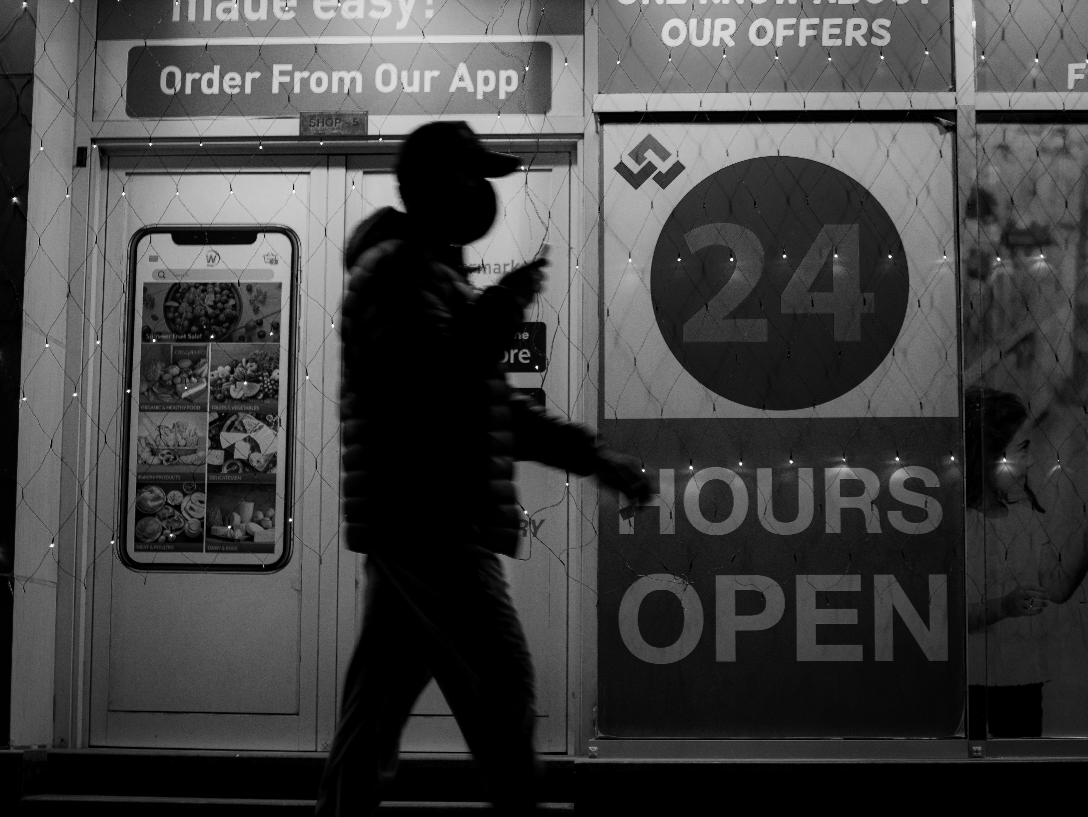 A man in a uniform standing in front of a storefront photo – Free ...
