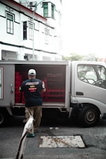 a man with a broom and a truck