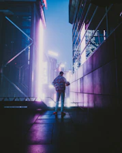 A shadowy figure standing on a rooftop overlooking a neon-lit cityscape at night, bathed in deep red and gold hues.